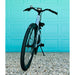 Front view of the Urtopia Carbon ST Glacier Blue ebike parked in front of aqua colored door. 