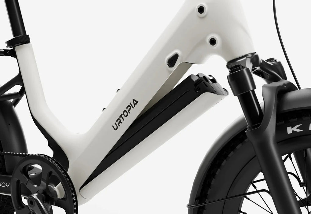 Close-up of a creme Urtopia Joy Carbon's battery coming off frame with 'Urtopia' branding on a white background
