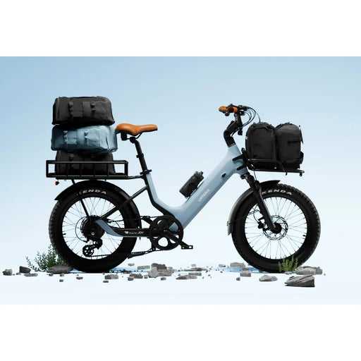 Urtopia Joy Carbon e-bike in glacier blue with cargo bags on a clear blue sky background