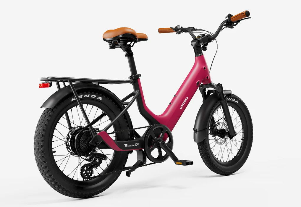 Rose Red Urtopia Joy Carbon electric bike at an angle with Kenda tires on a white background